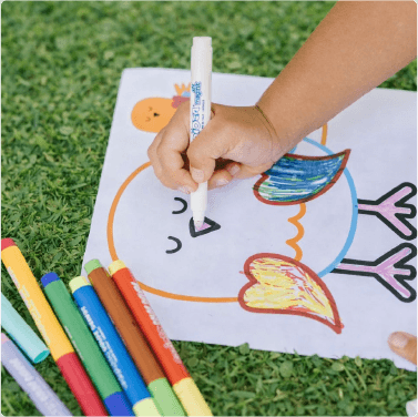 Child coloring with markers